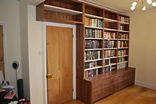 Fitted solid wood grain-matched book cabinet with under-storage